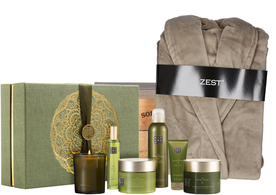  The image is of a green and gold box with a brown bathrobe on top of it. The box contains a candle, a body scrub, a body cream, and a shower gel. The image represents the search query 'Rituals and prayers for inviting a strong khodam companion'.
